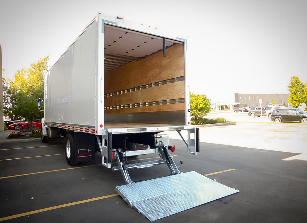 TWC Express box truck with hydraulic liftgate deployed for ground-level delivery